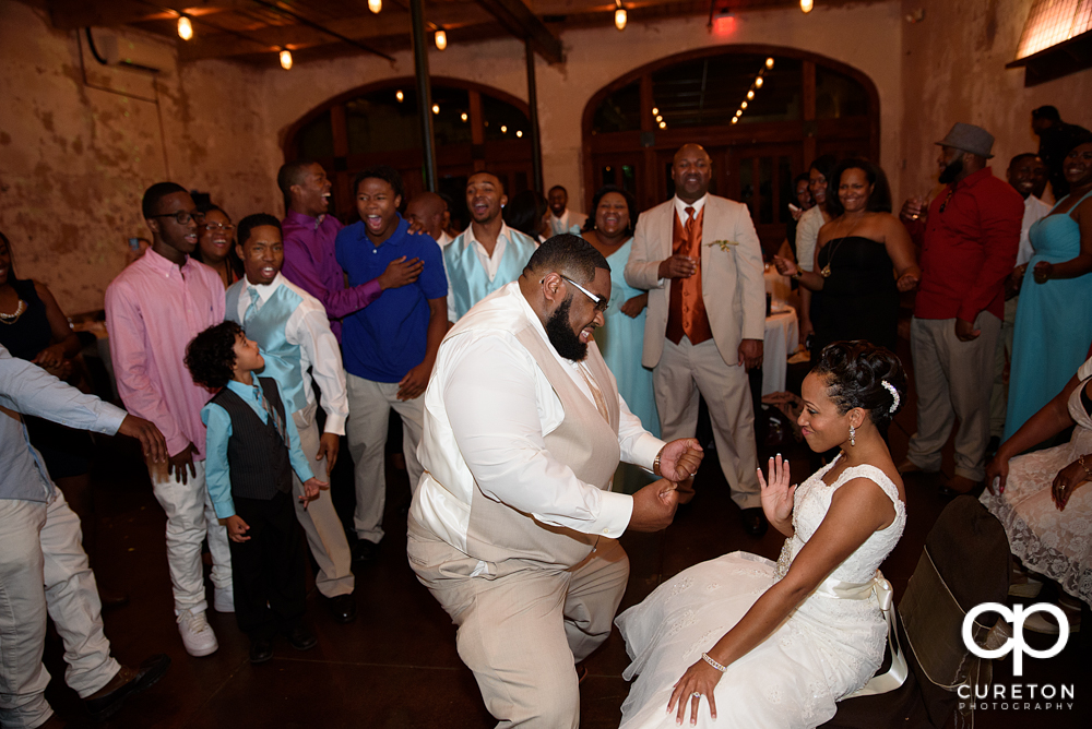 Groom taking off the garter.