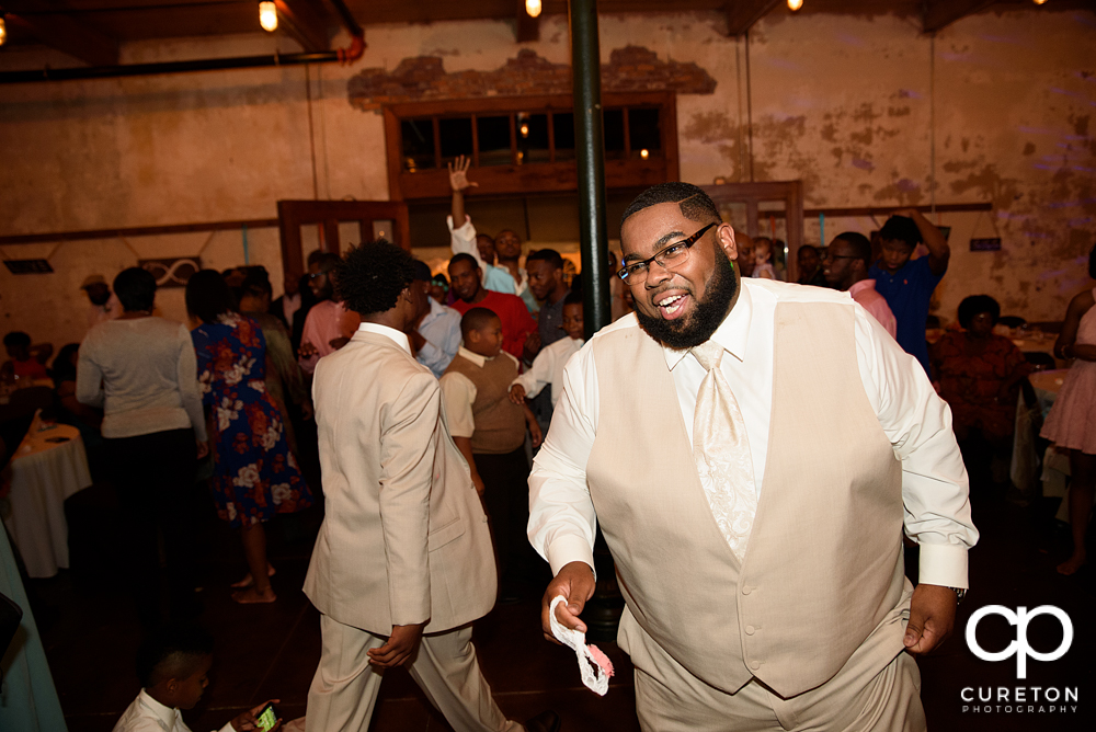 Groom taking off the garter.