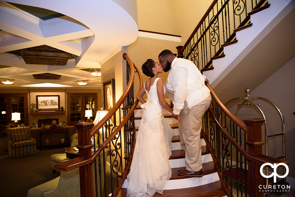 The bride and groom going upstairs.