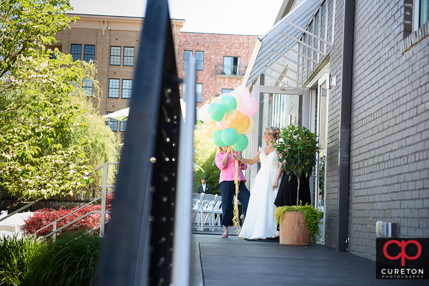 Bride holding balloons ready for her first look.