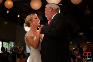Bride and father are dancing.