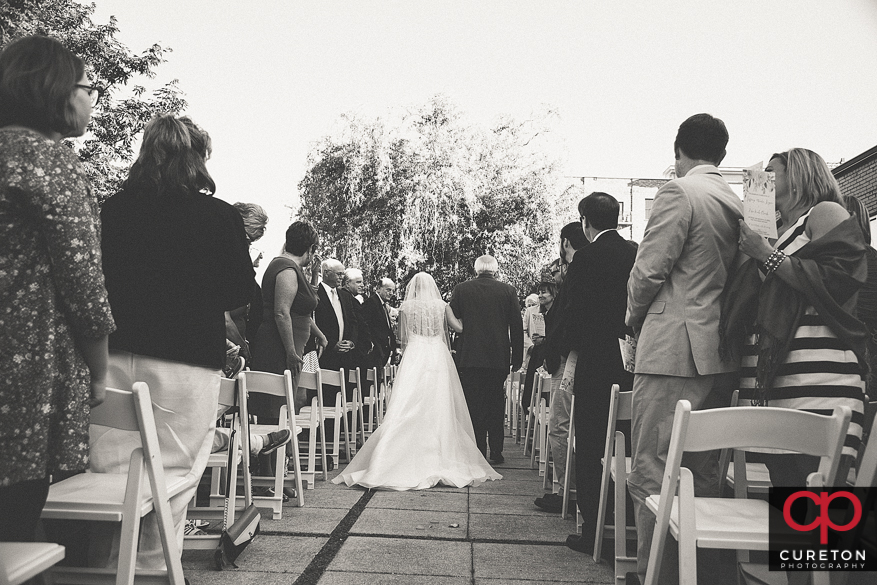 Bride and her father walking down the aisle.