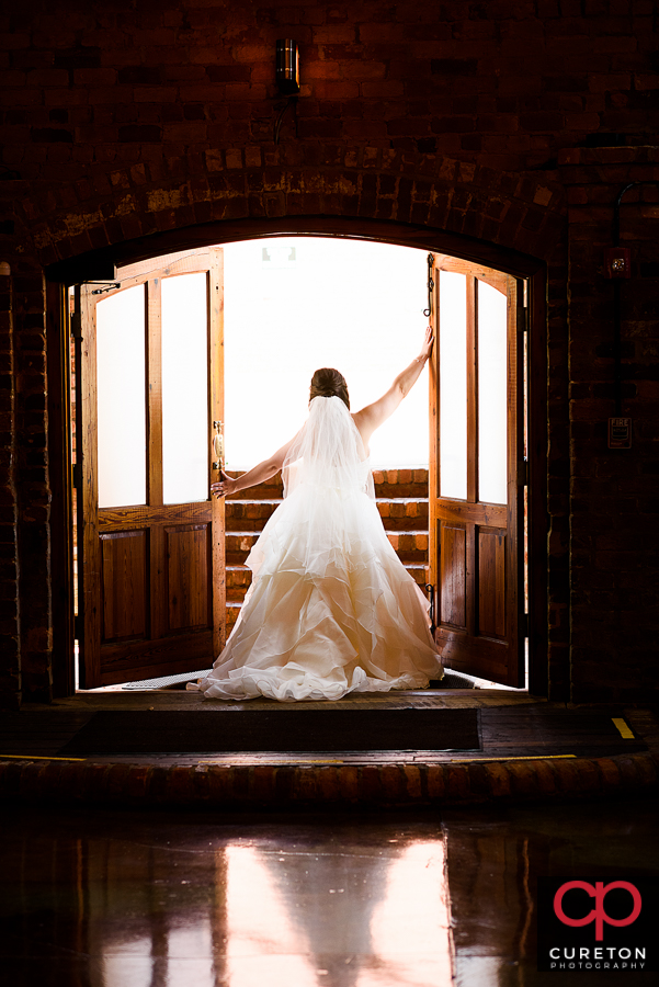Bride standing in the doorway during her Old Cigar Warehouse bridal session.