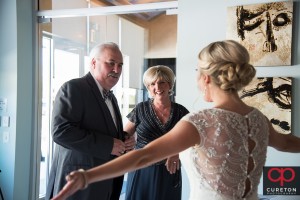Bride's parent's see her for the first time in the dress.