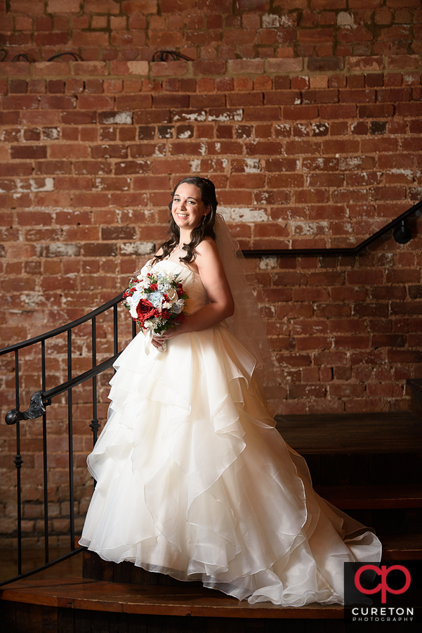 Bride holding her flowers on the Old Cigar Warehouse staircase.