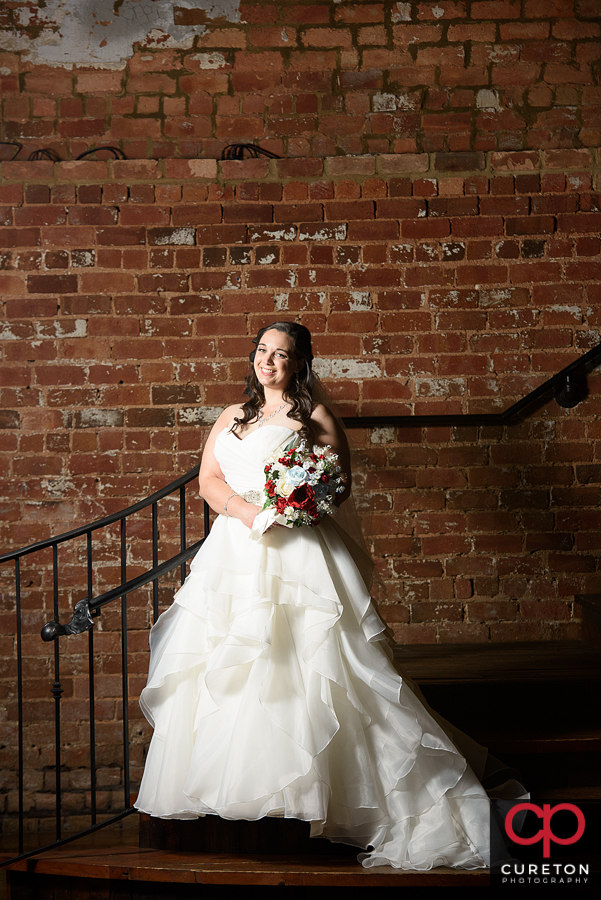Bride on the staircase at Old Cigar Warehouse.