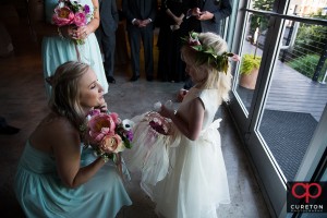 Bridesmaid talking to the flower girl.