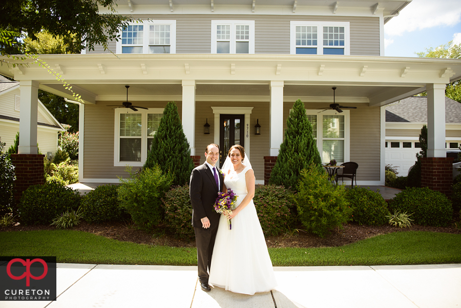 Married couple in front of their home.