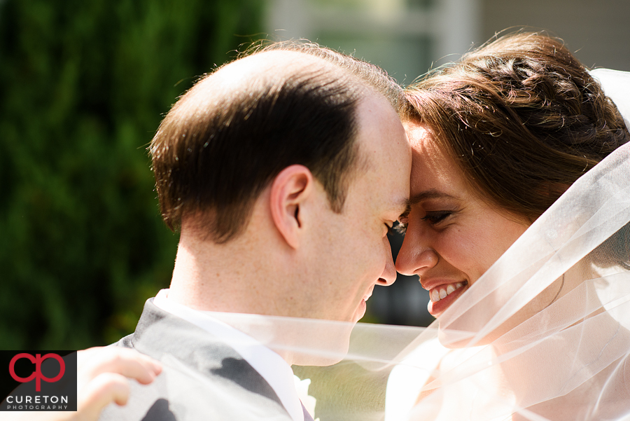 Bride and groom cuddling after their wedding.