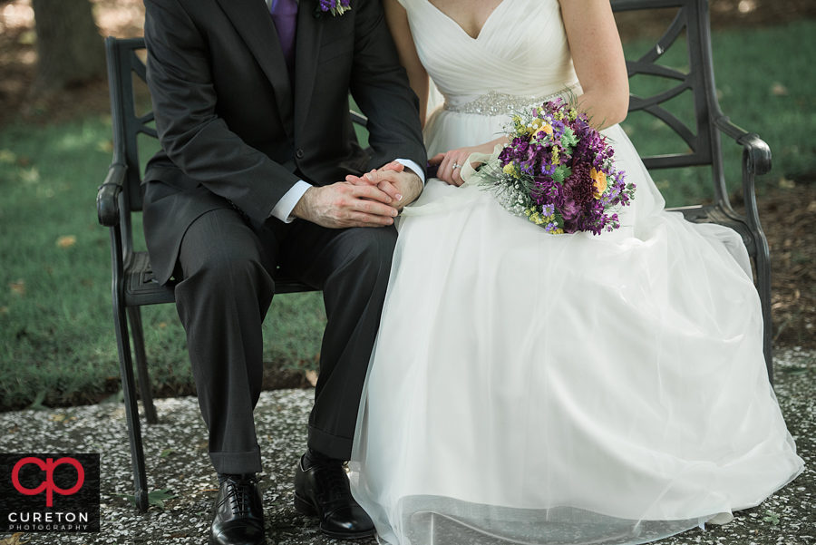 Bride and groom holding hands.