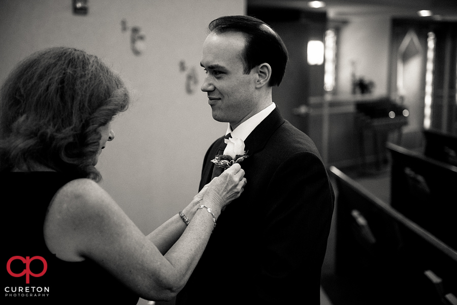 Groom getting a boutonniere .