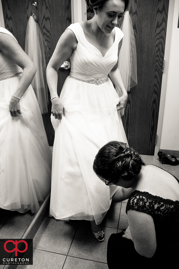 Bride putting on her shoes.