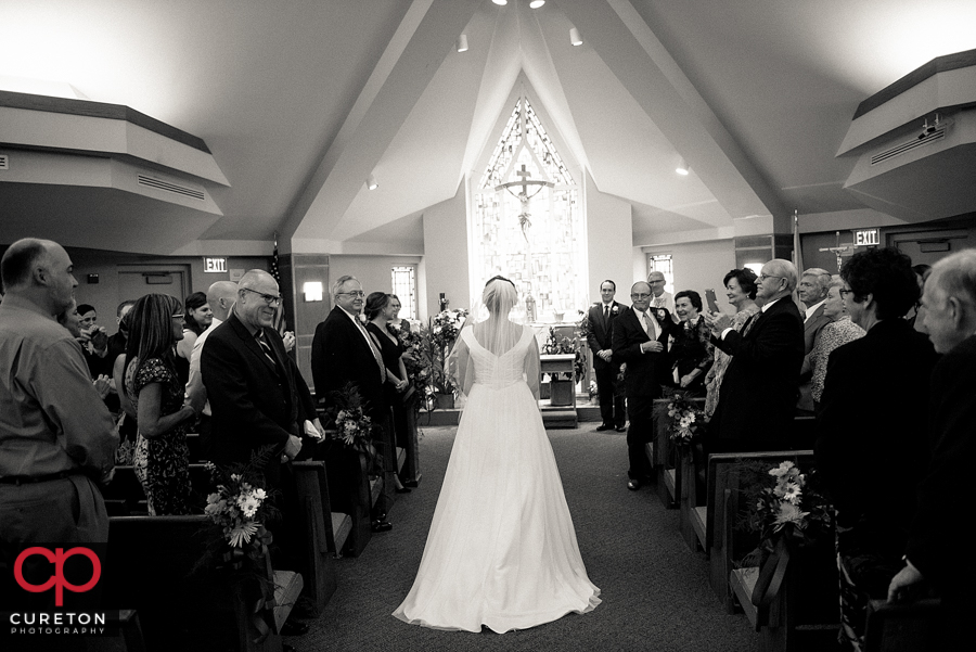 Bride walking down the aisle at her wedding at St. Matthew Catholic church in Charlotte NC.