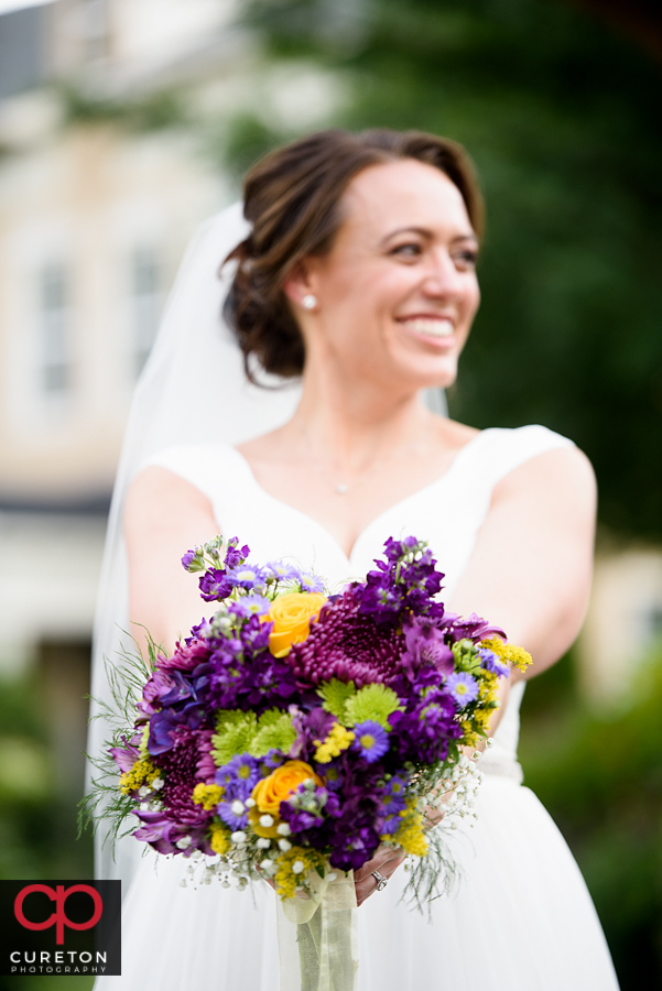 Bride and a beautiful yellow and purple bouquet.