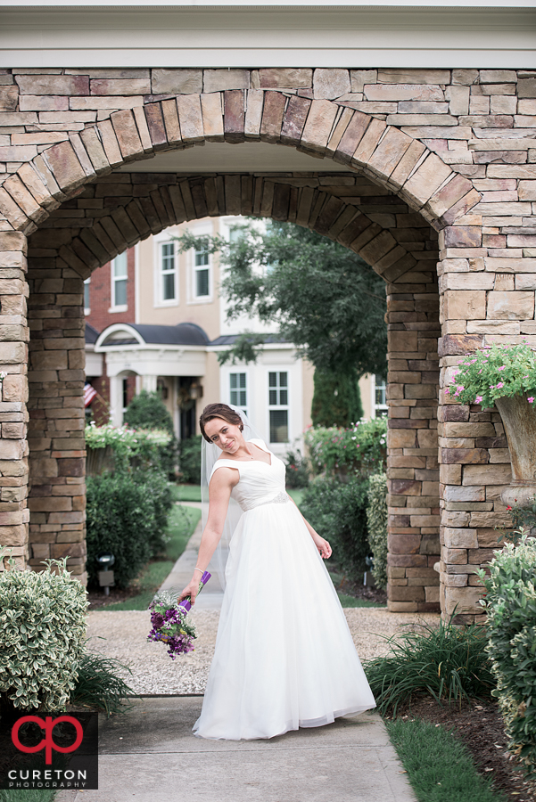 Bride standing in an archway.