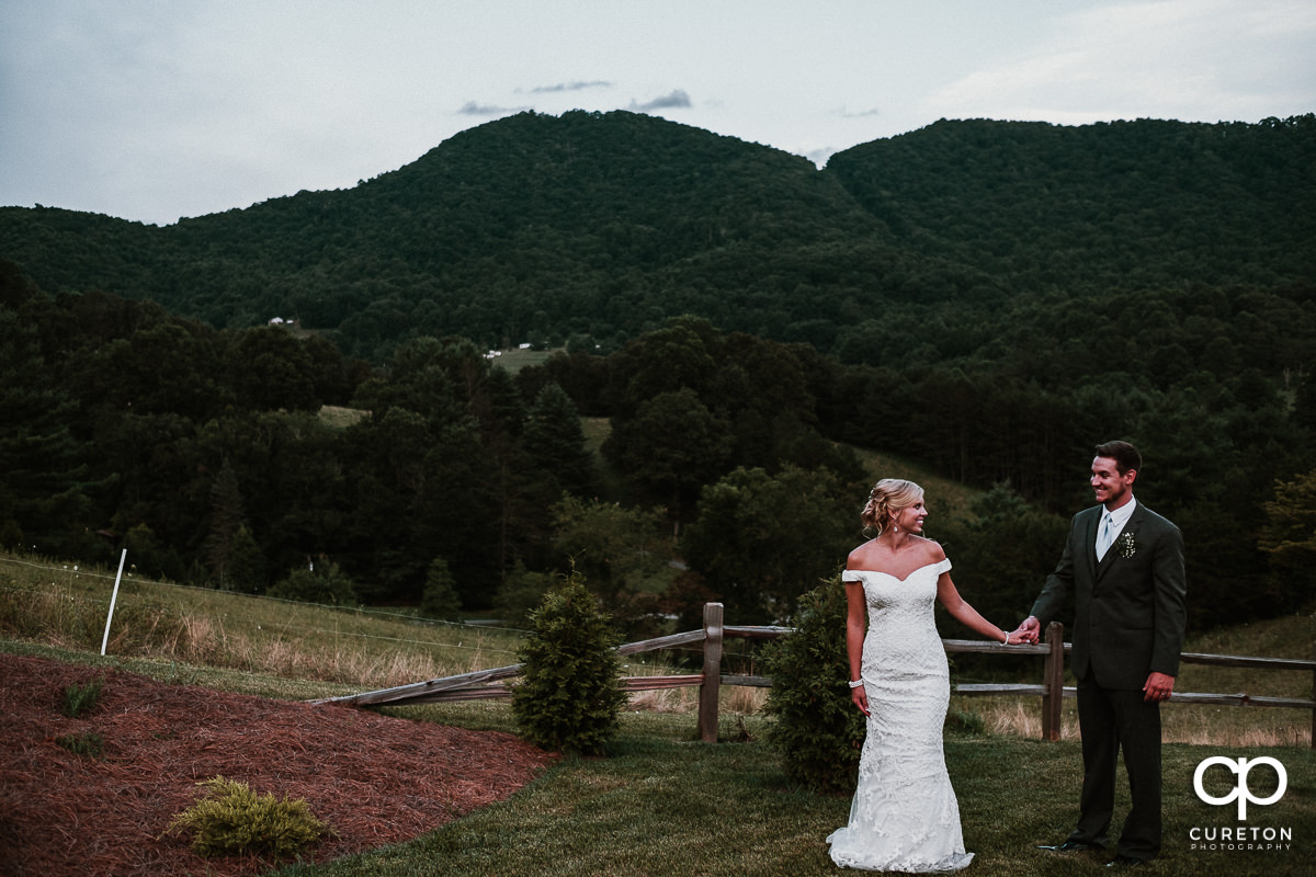 Bride and groom walking hand in hand after their wedding at Chestnut Ridge in Canton,NC.