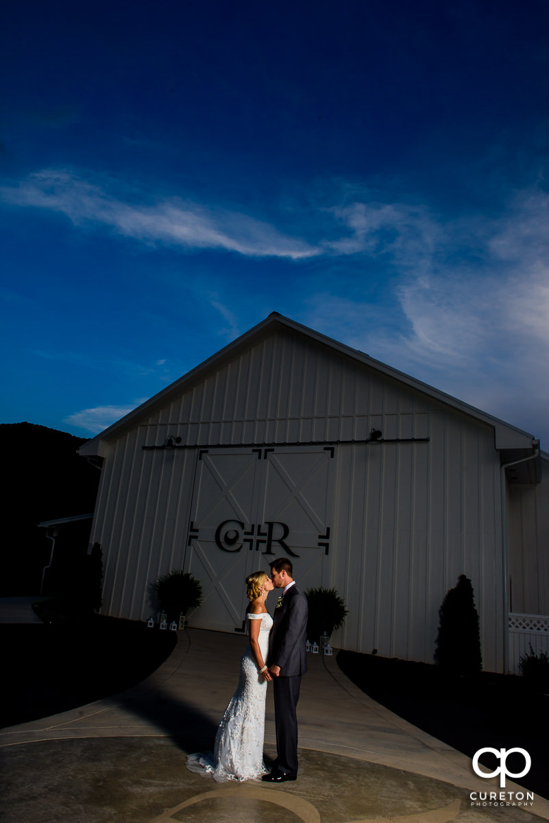 Bride and groom in front of Chestnut Ridge at sunset on their wedding day.