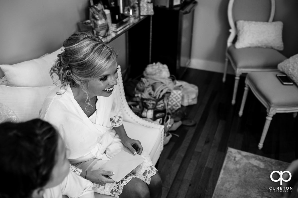 Bride smiling while reading a card.