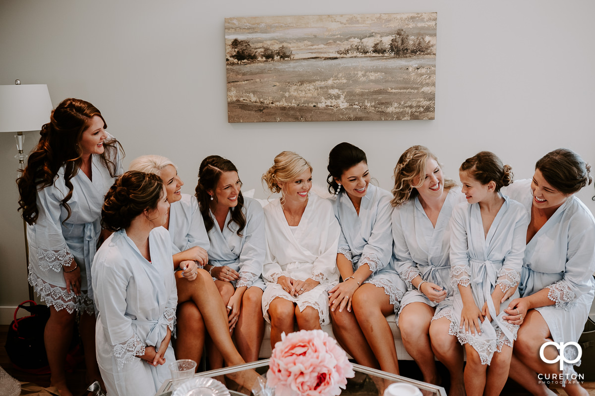 Bridesmaids laughing before getting ready for the wedding ceremony.
