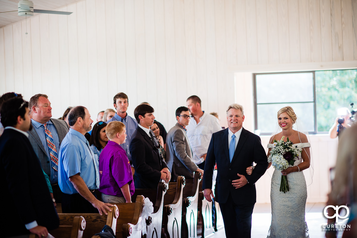 Bride walking down the aisle with her father.