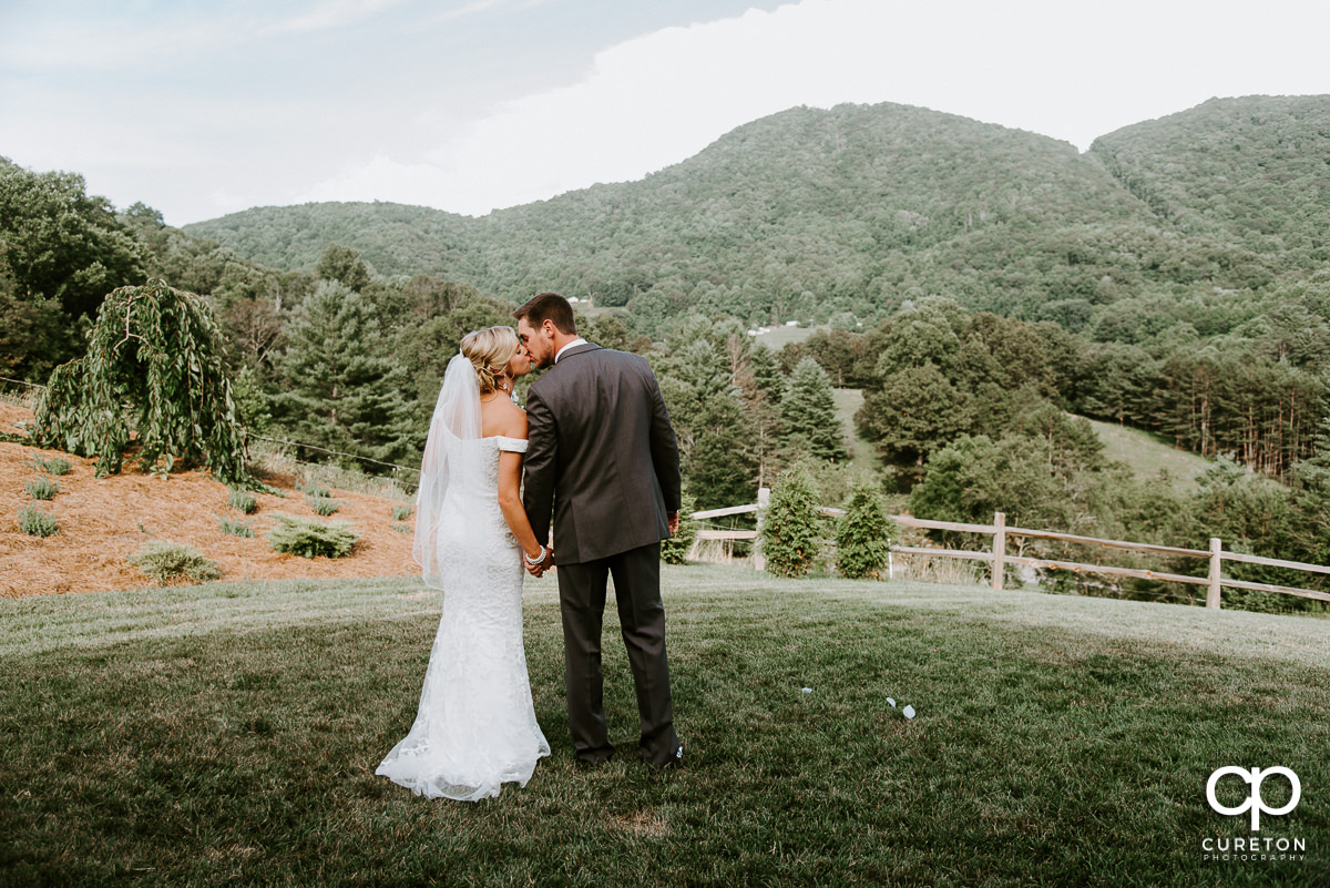 Bride and groom kissing.