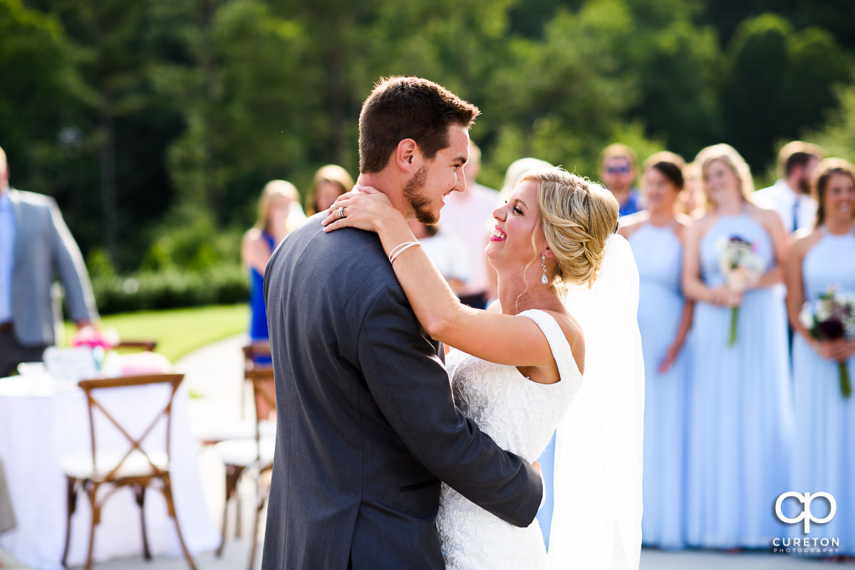 Bride and groom sharing a first dance.