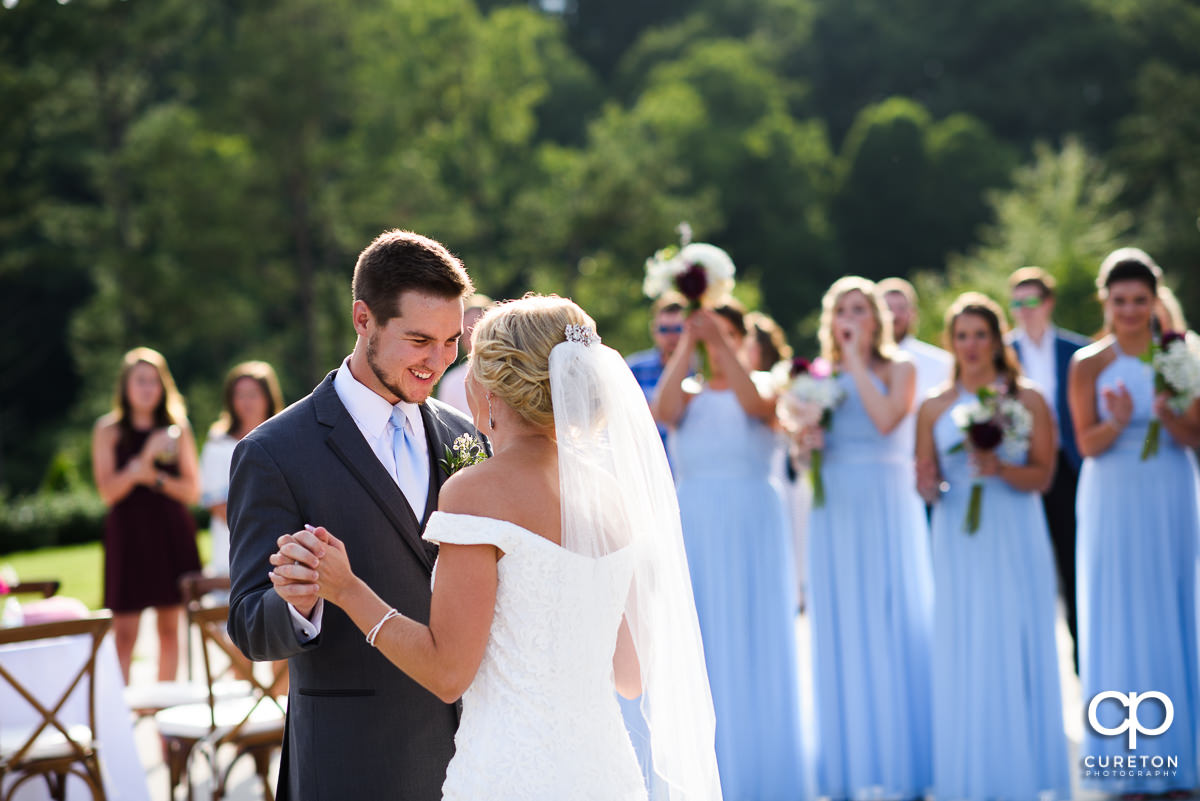 Groom looking down at his bride.