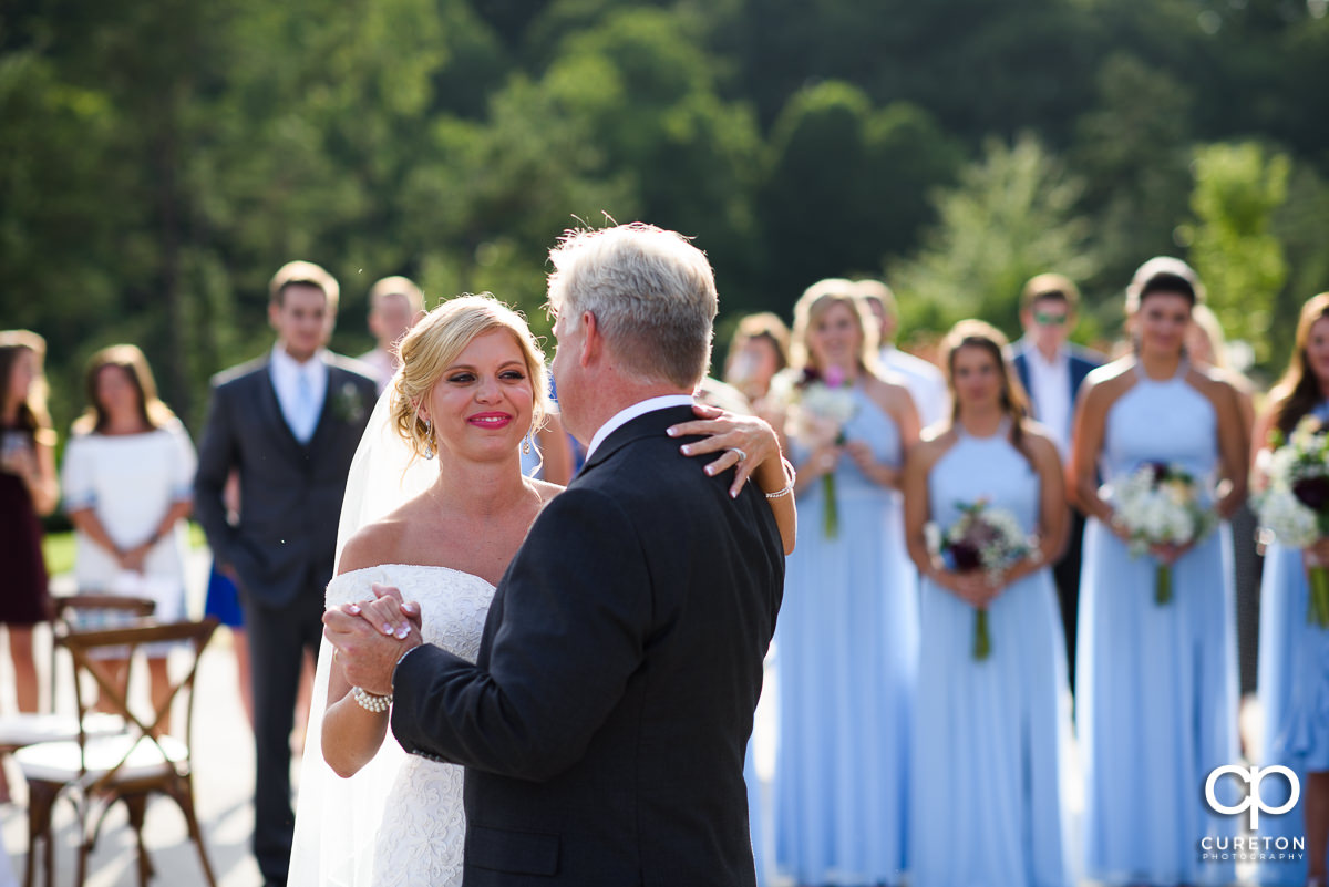 Bride smiling at her father.