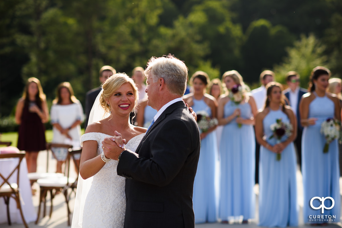 Bride smiling during the father-daughter dance.