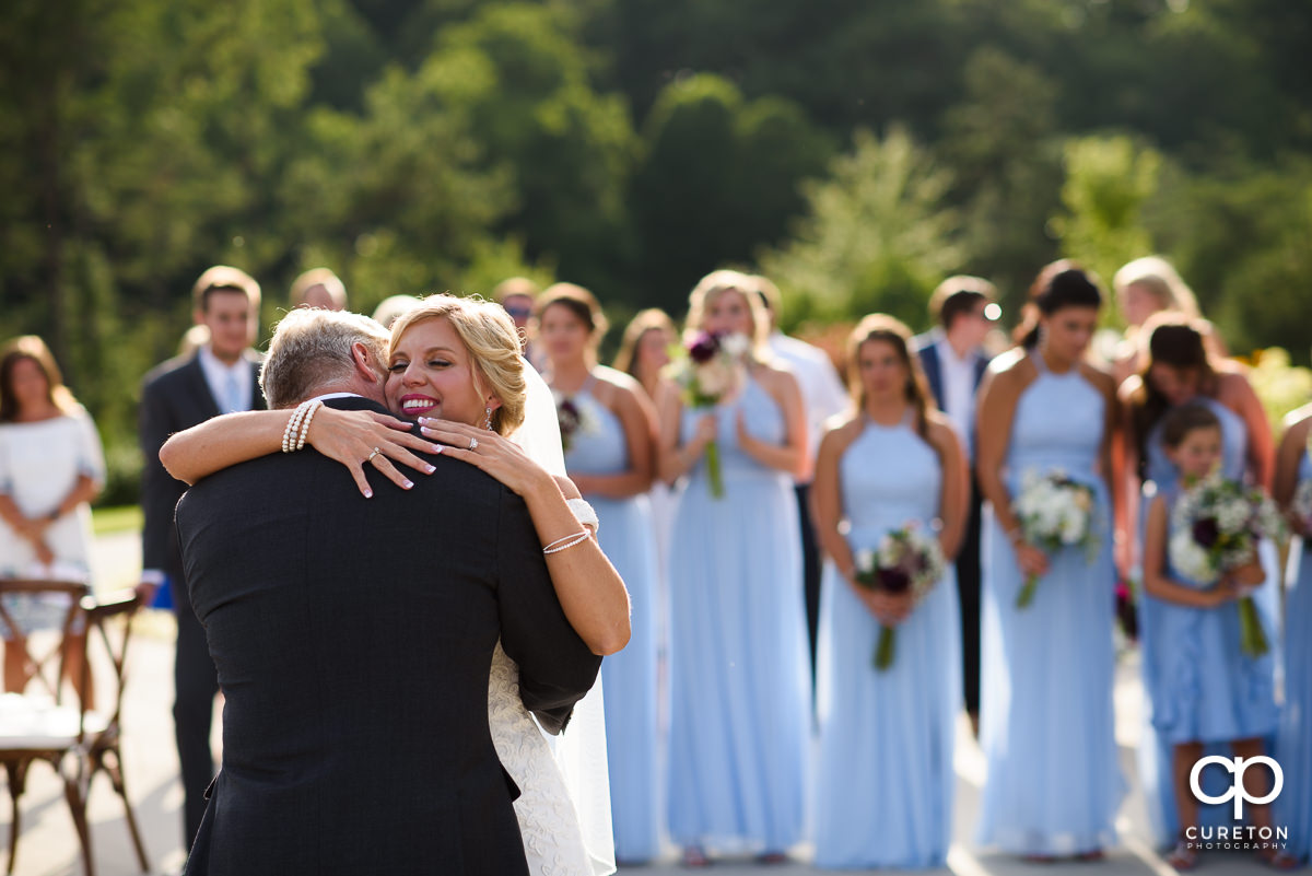 Bride hugging her dad.