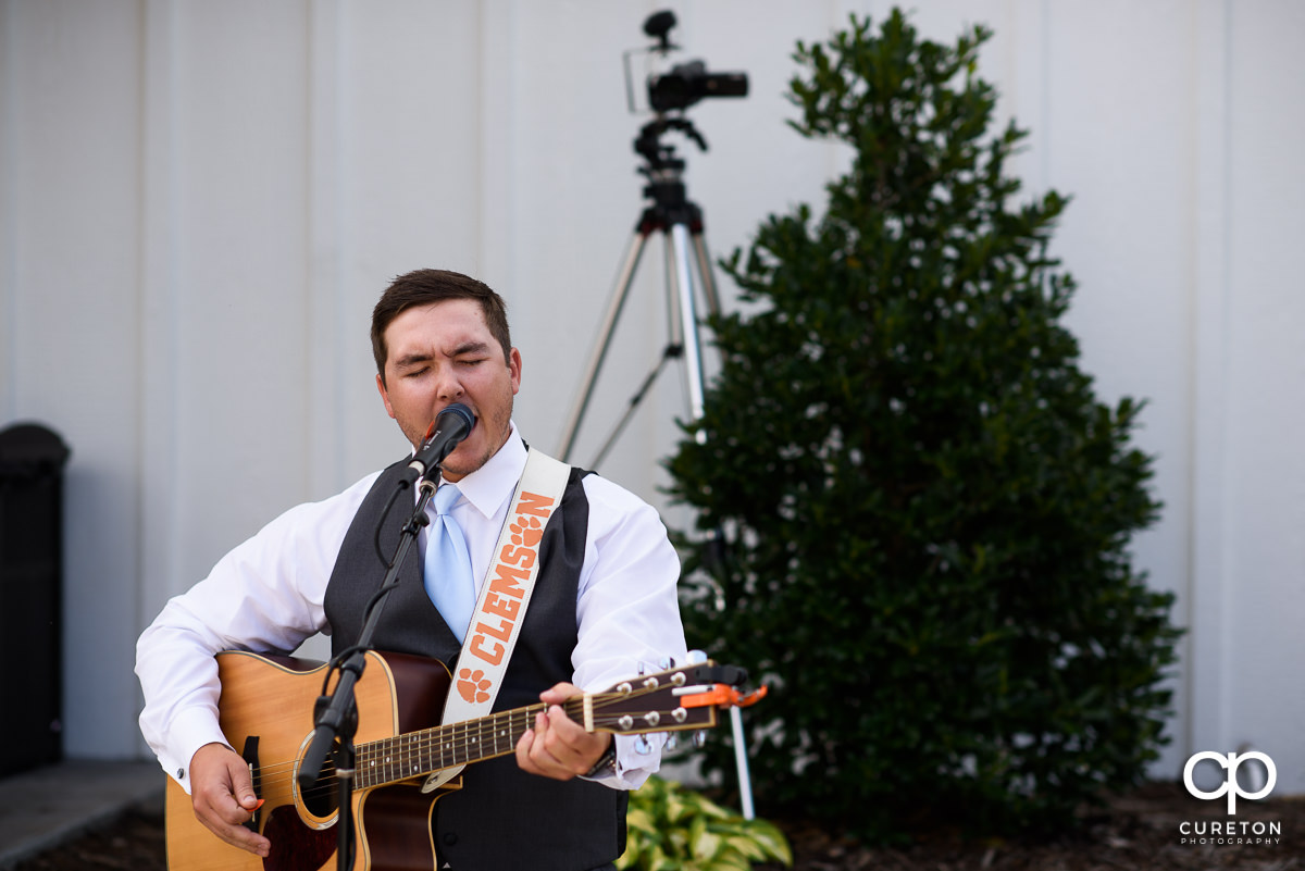 Groomsmen singing at the reception.