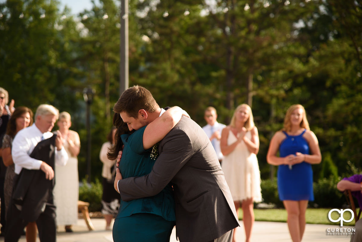 Groom hugging his mother.