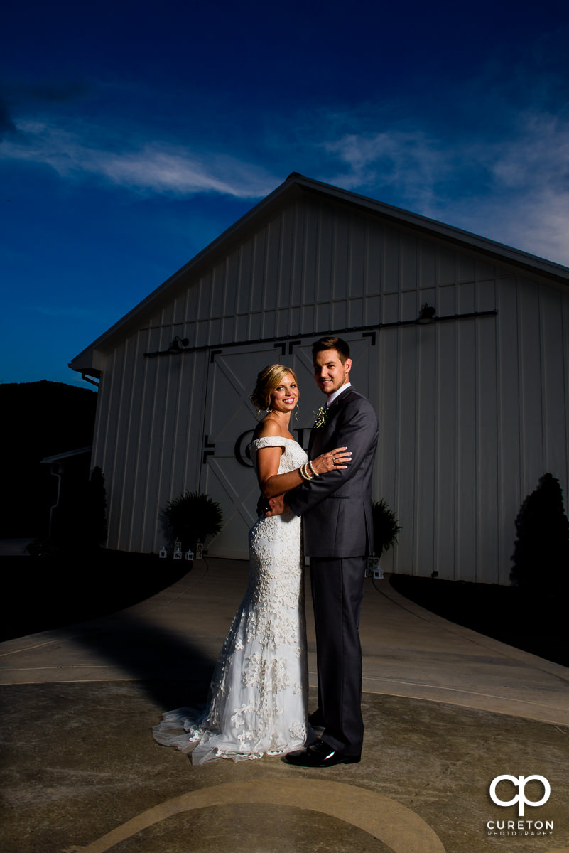 Bride and groom dancing in front of Chestnut Ridge at sunset.