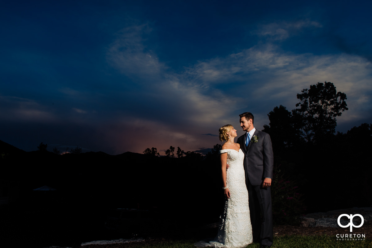 Bride and groom gazing at each other underneath a North Carolina sunset on their wedding day.