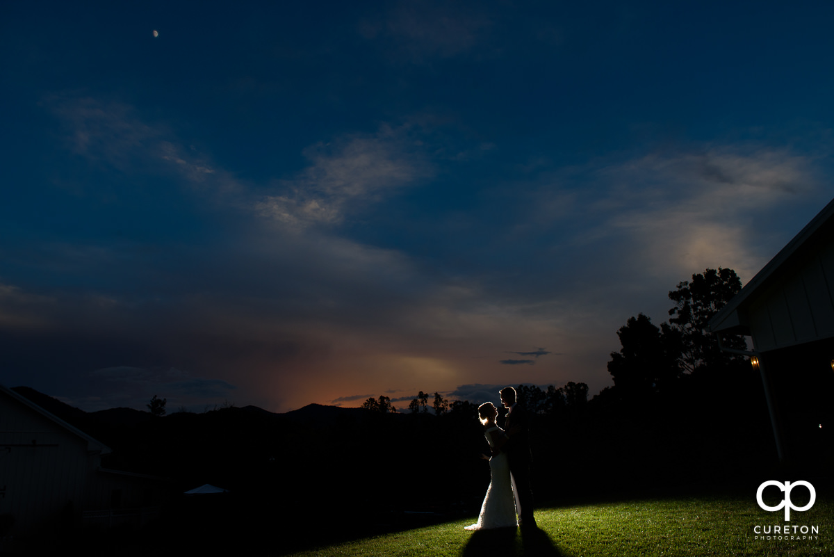 Bride and groom dancing at sunset at their Chestnut Ridge wedding.