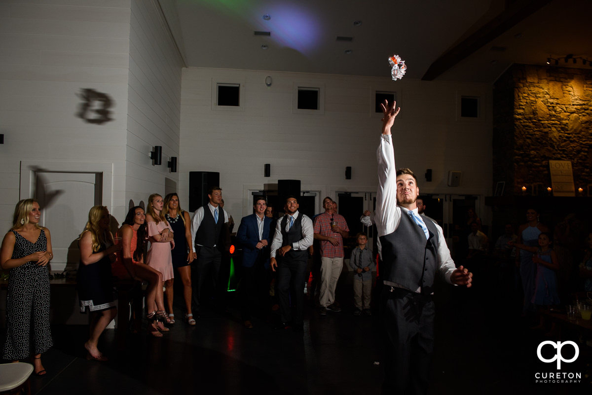 Groom tossing the garter.