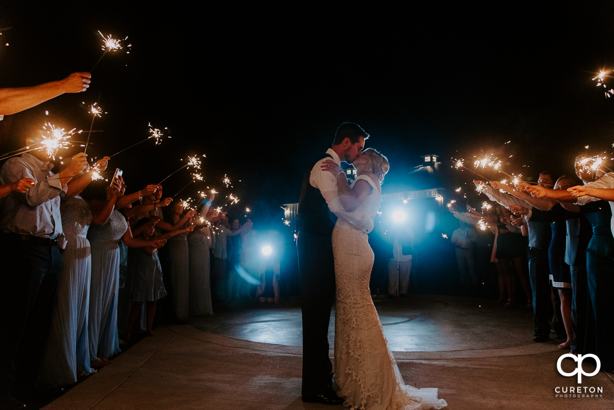 Epic kiss during a sparkler exit at the wedding reception.