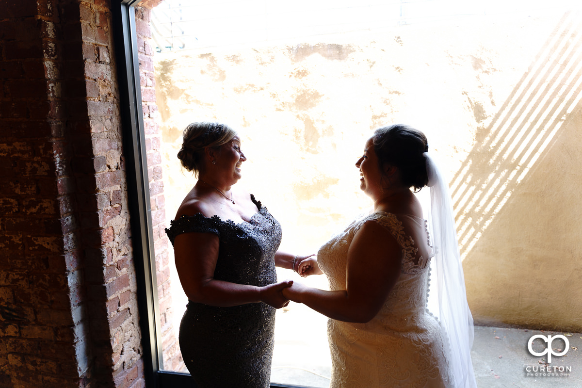 Bride and her mother sharing a moment before the wedding.