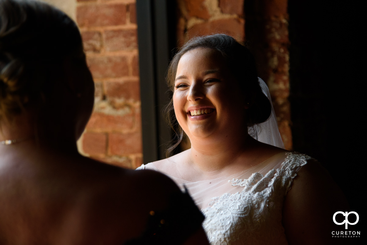 Bride smiling at her mother.