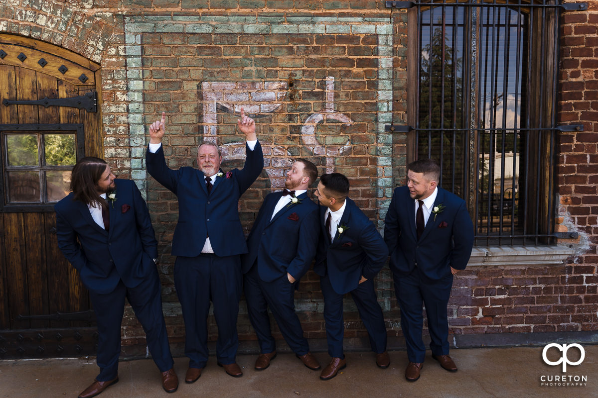 Groomsmen cutting up at The Old Cigar Warehouse in downtown Greenville before the wedding ceremony.