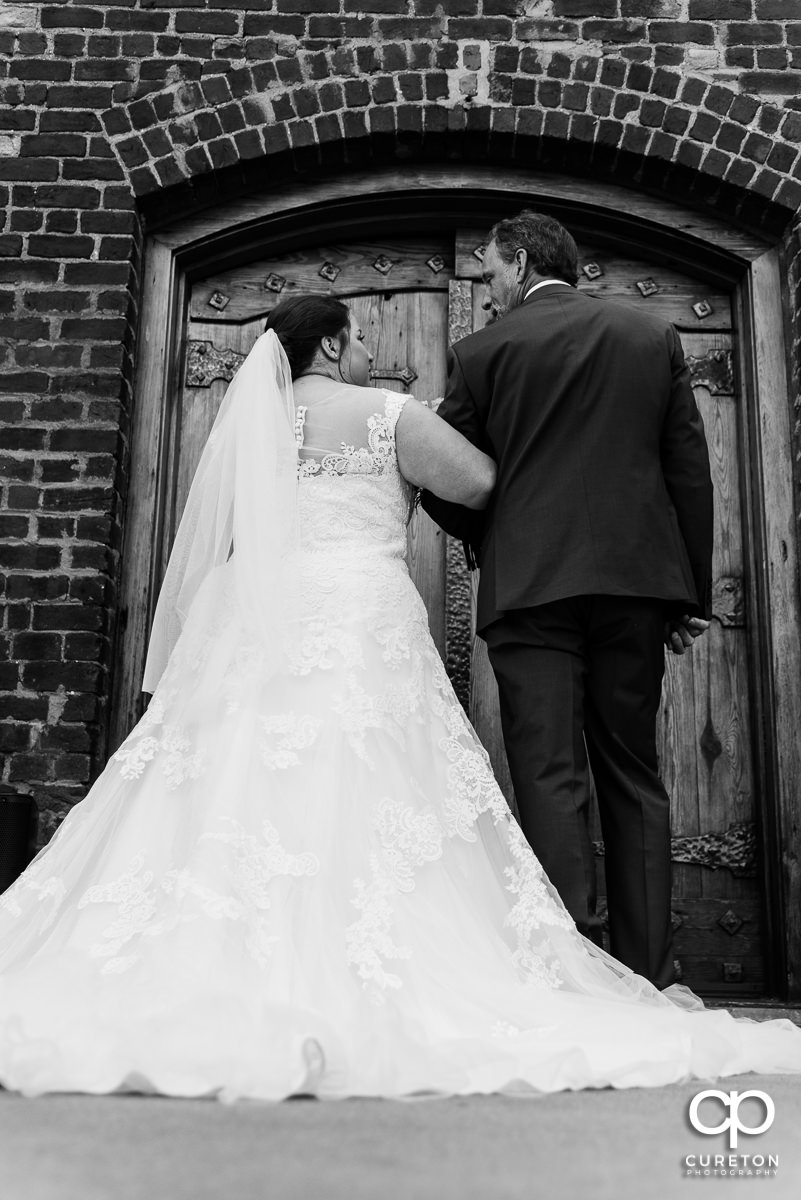 Bride and her father getting ready to walk down the stairs at The Old Cigar Warehouse in downtown Greenville before the wedding ceremony.