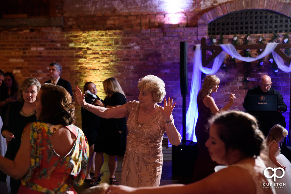 Guests dancing at The Old Cigar Warehouse to the sounds of Greenville wedding DJ Jumping Jukebox.
