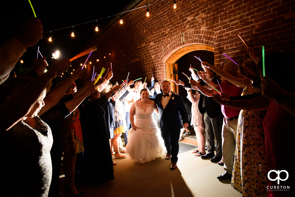 Bride and groom making a grand exit at The Old Cigar Warehouse wedding.