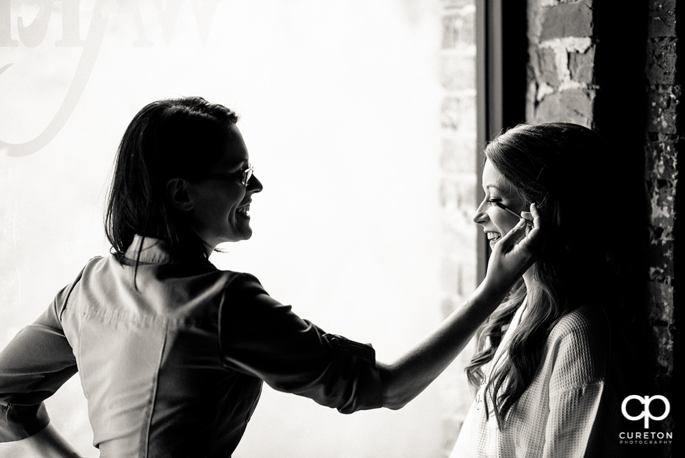 Bride getting makeup applied by Katie from Cotton Rouge.