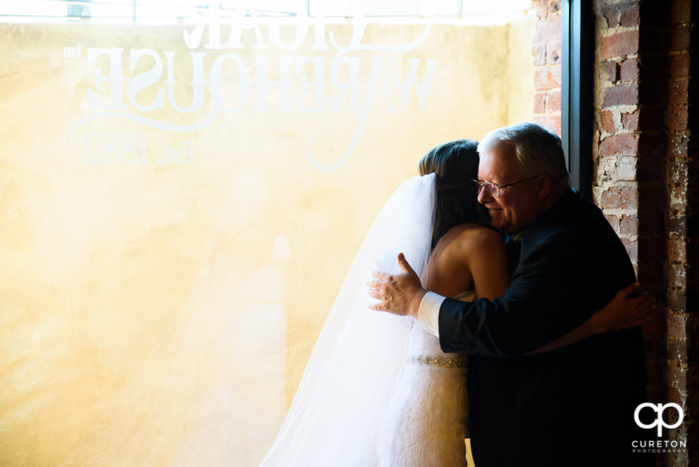 Bride's father sees her in the dress for the first time.