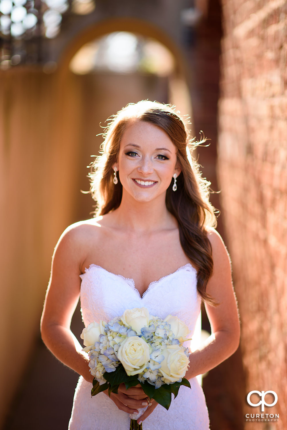 Bride in gorgeous sunlight outside the Old Cigar Warehouse before her wedding.