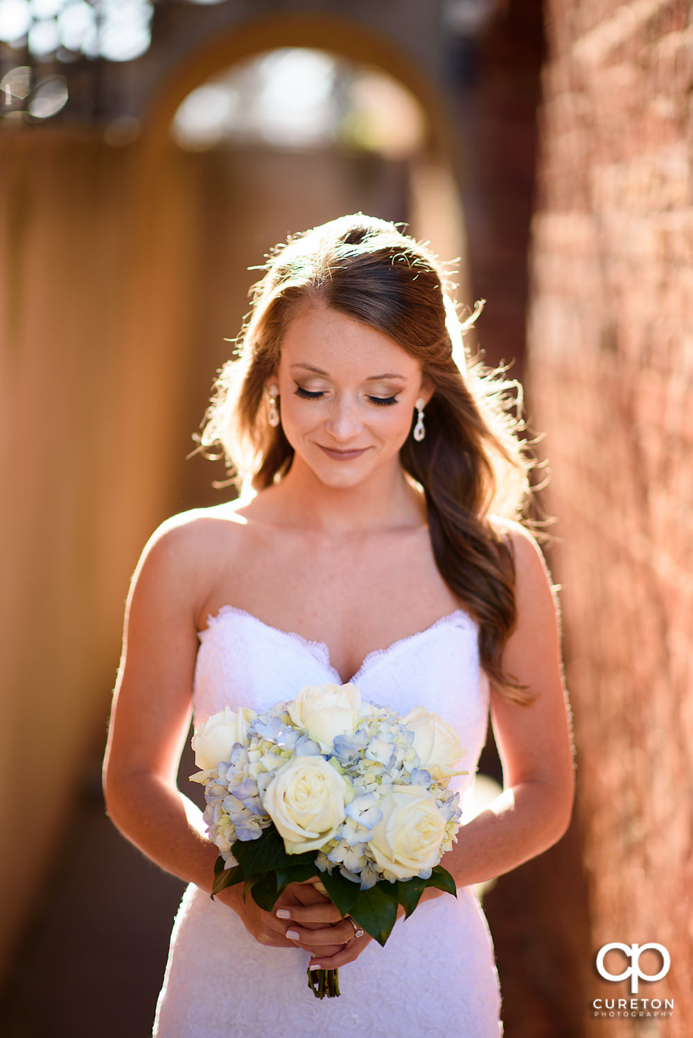 Bride in gorgeous sunlight outside the Old Cigar Warehouse before her wedding.