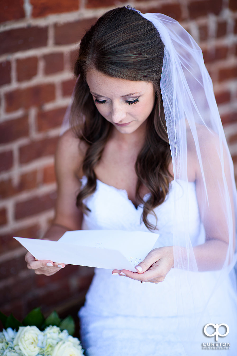Bride reading a note from the groom.