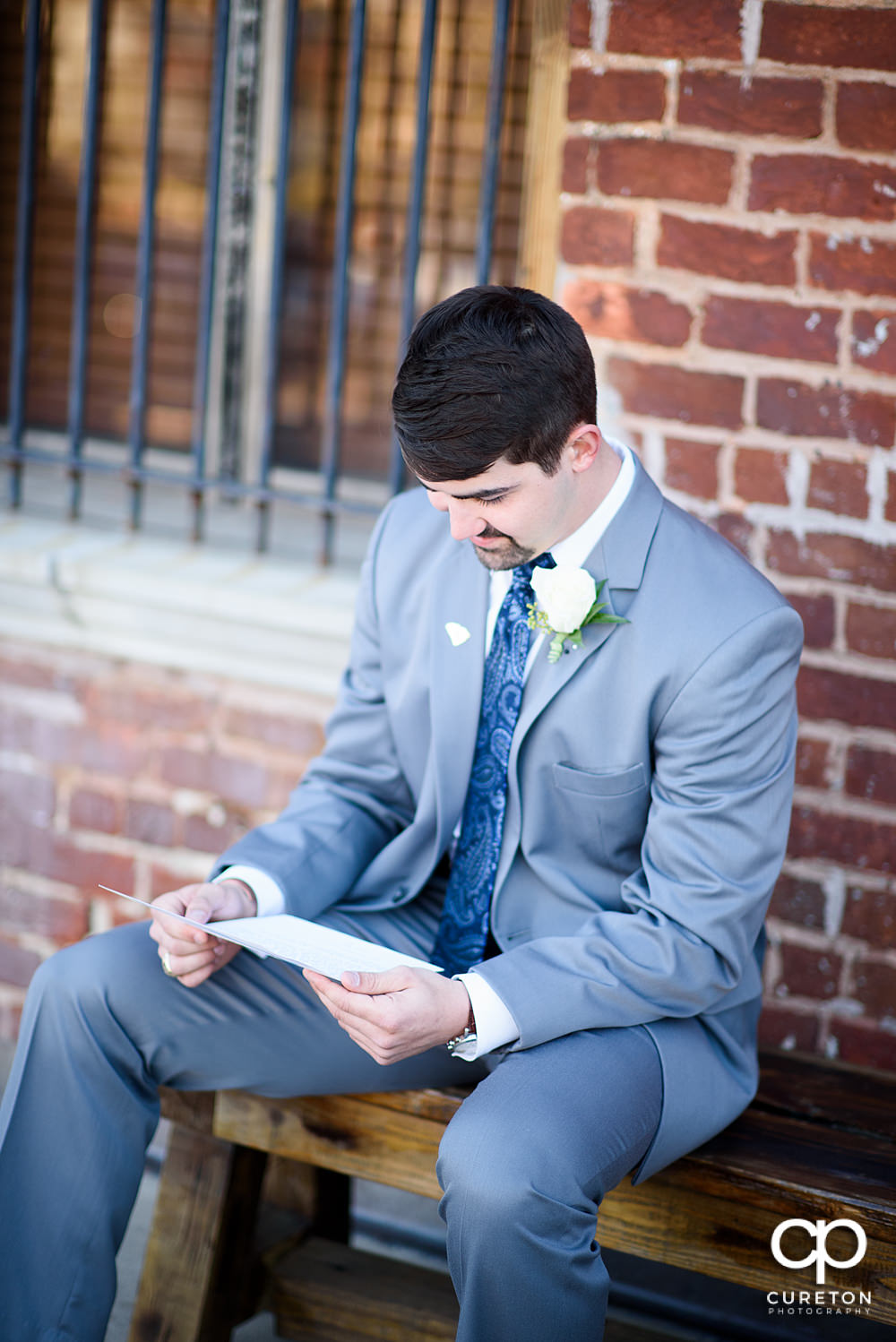 Groom reading a letter from his bride.