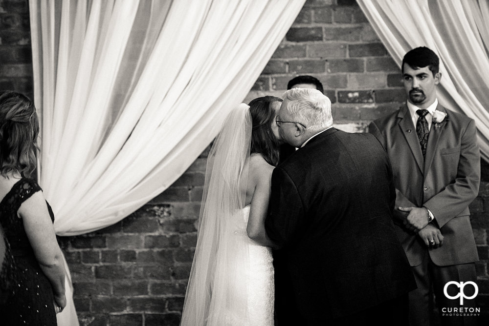 Brides dad giving her away.